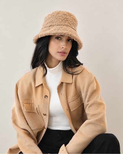 Model wearing Chestnut Nube teddy bucket hat with a camel coat
