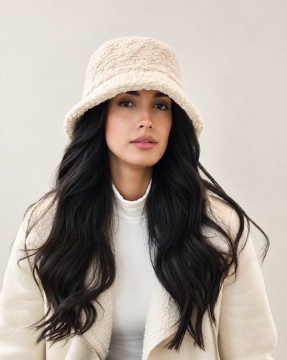 Model wearing cream Nube teddy bucket hat with ivory jacket