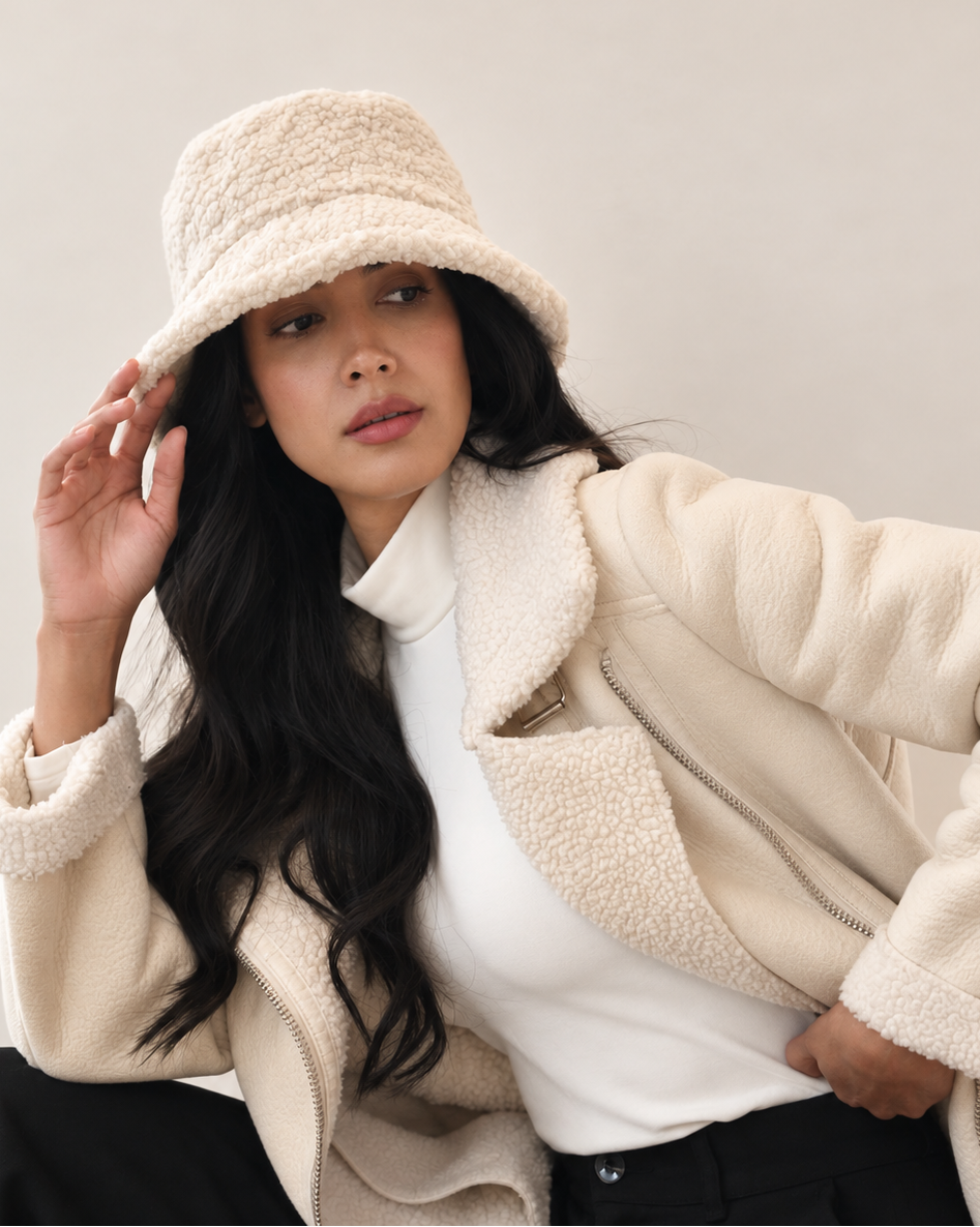 Model adjusting Birch Nube teddy bucket hat with cream outerwear