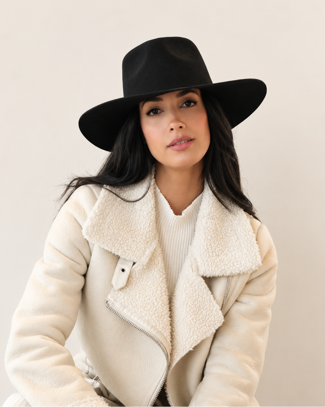 Model wearing Sable Wool Fedora Hat in Shadow black with cream coat