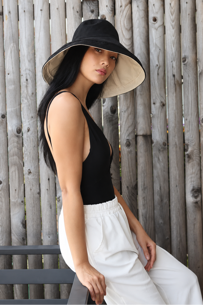 Model wearing Noir + Wheat Brisa canvas bucket hat with summer outfit