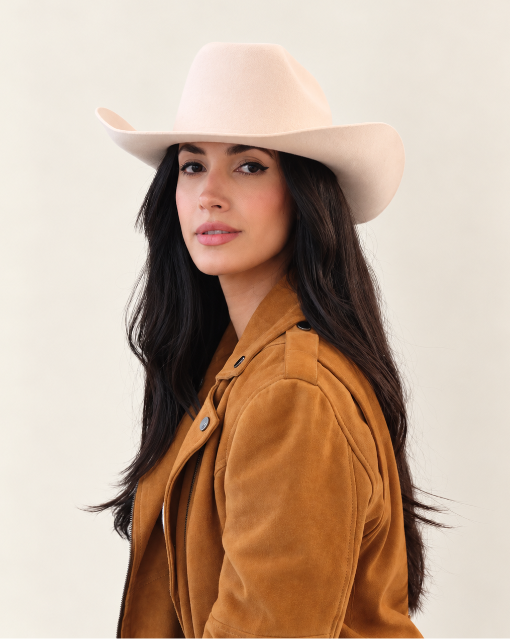 Side angle of model wearing Birch Clayton Wool Cowboy Hat with tan jacket