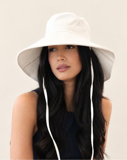 Model wearing Cotton white Onda Canvas Bucket Hat with navy sleeveless top
