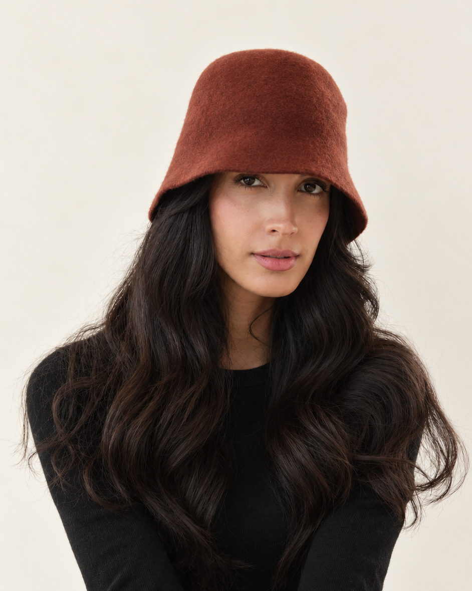 Model wearing Terracotta Ember Wool Bucket Hat with black outfit