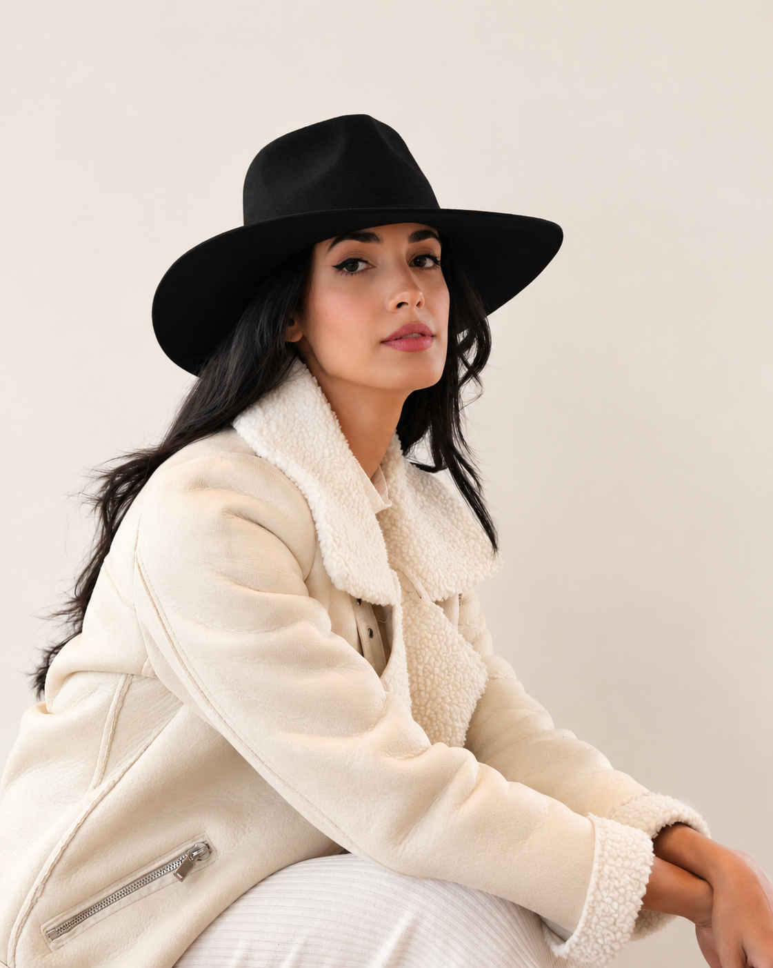Side view of Sable Wool Fedora Hat in Shadow black styled with cream outerwear