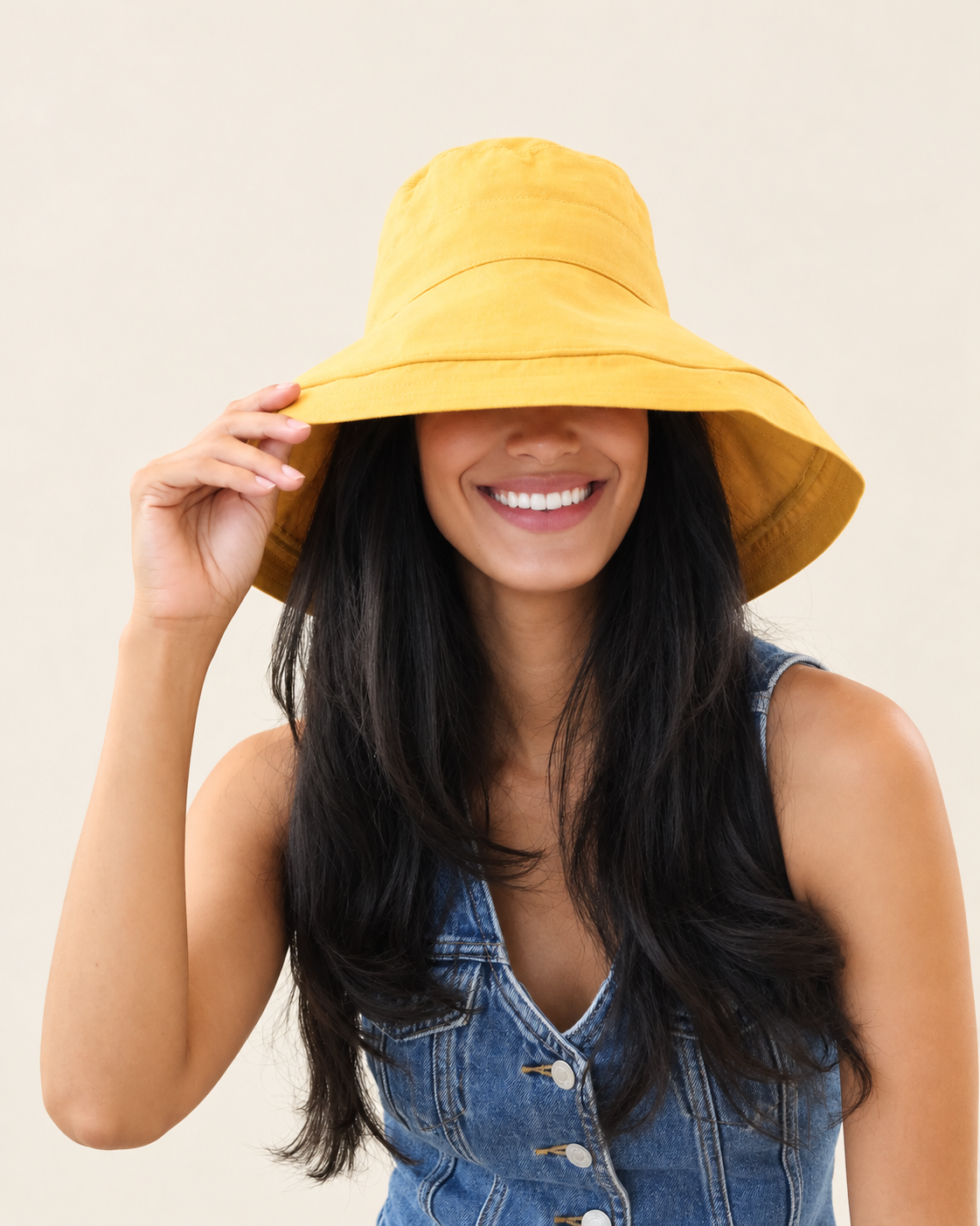 Front view of model wearing Marigold Brisa canvas bucket hat