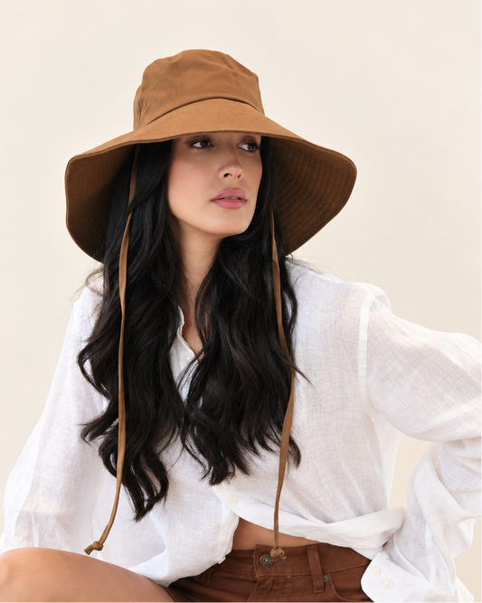 Model wearing Chestnut Onda Canvas Bucket Hat styled with a white blouse