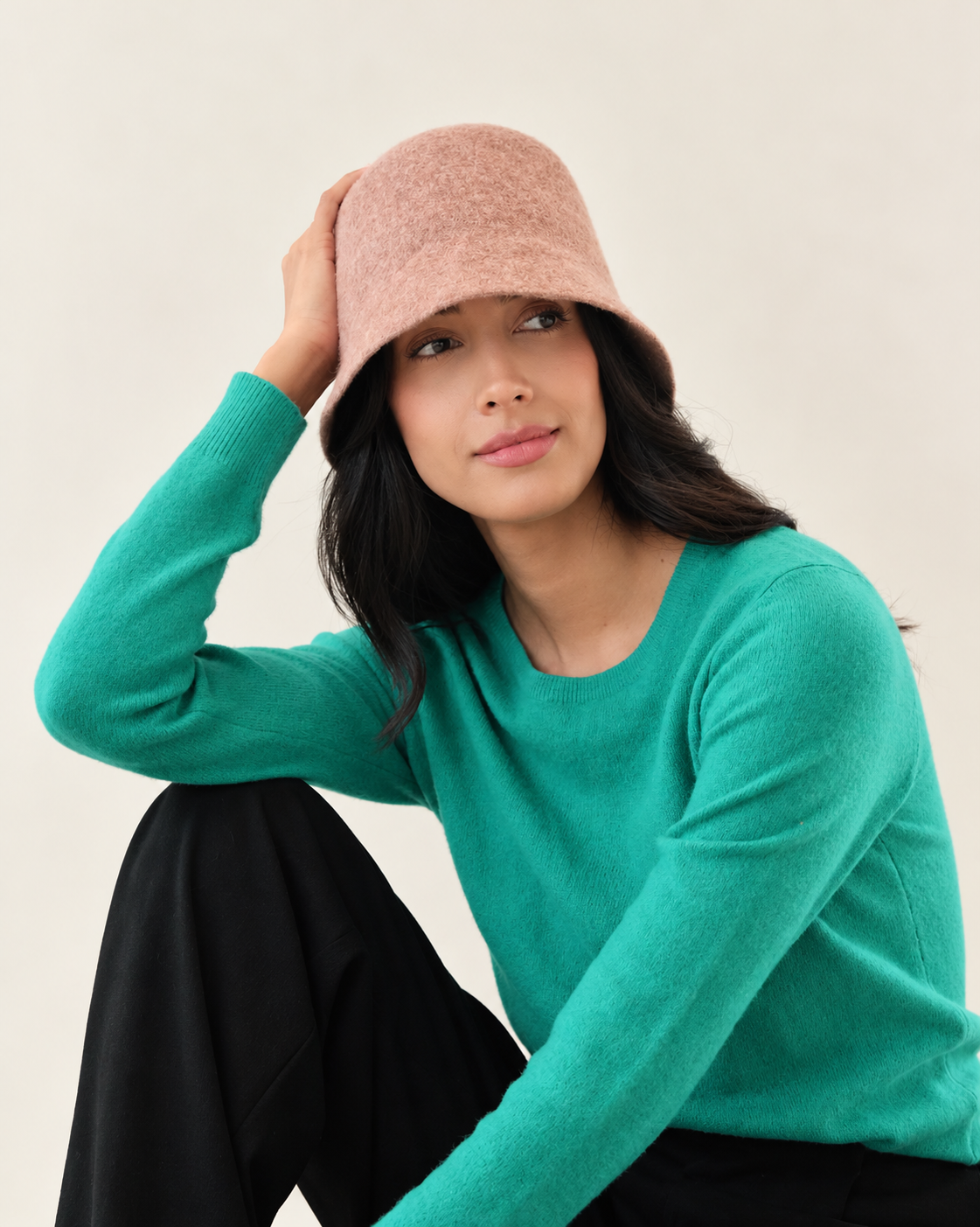 Model wearing Umber Ember Wool Bucket Hat with green sweater